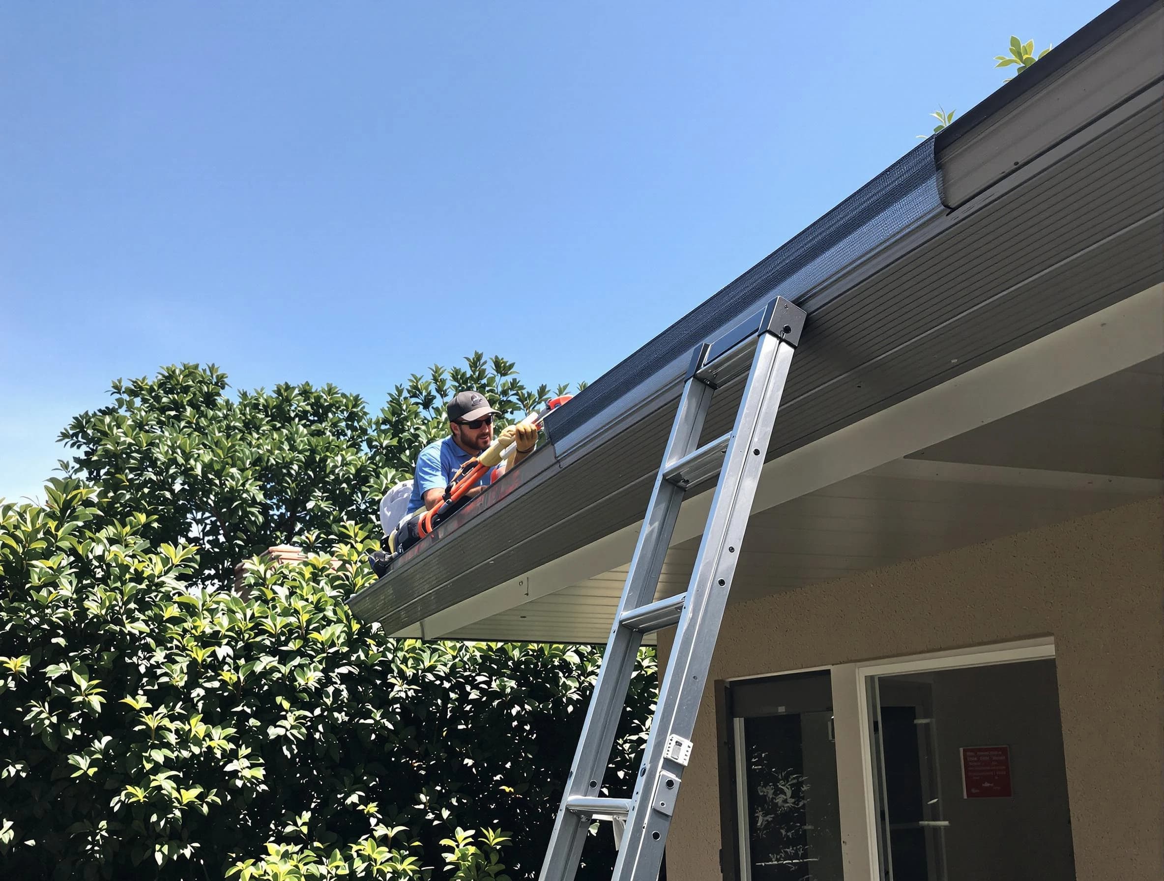 Stow Roofing Company installing gutter guards for a homeowner in Stow, OH